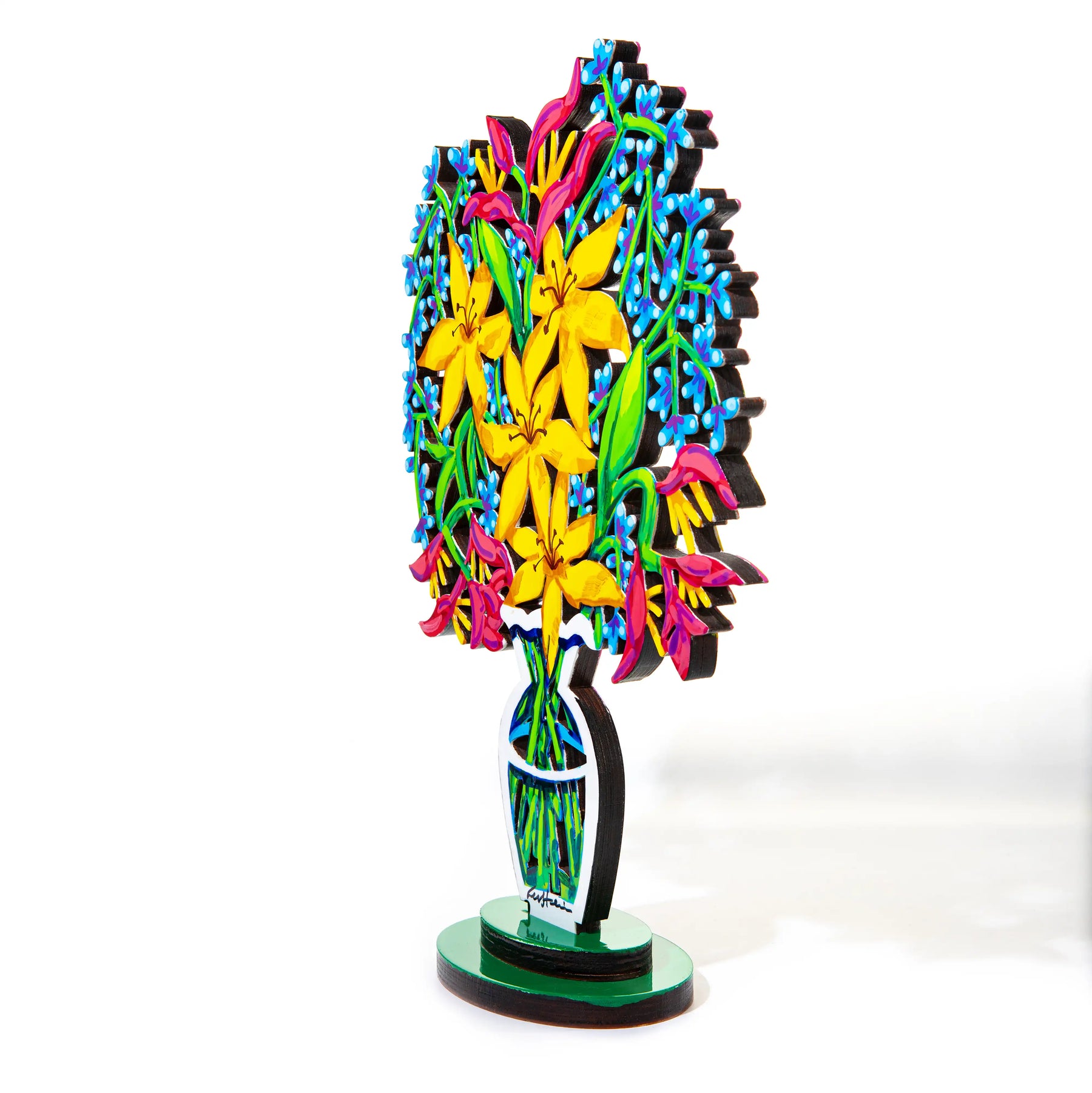 A vibrant hand-painted sculpture of a bouquet of yellow and blue flowers with red accents, displayed in a stylized, modern vase is seen at an angle against a white backdrop.
