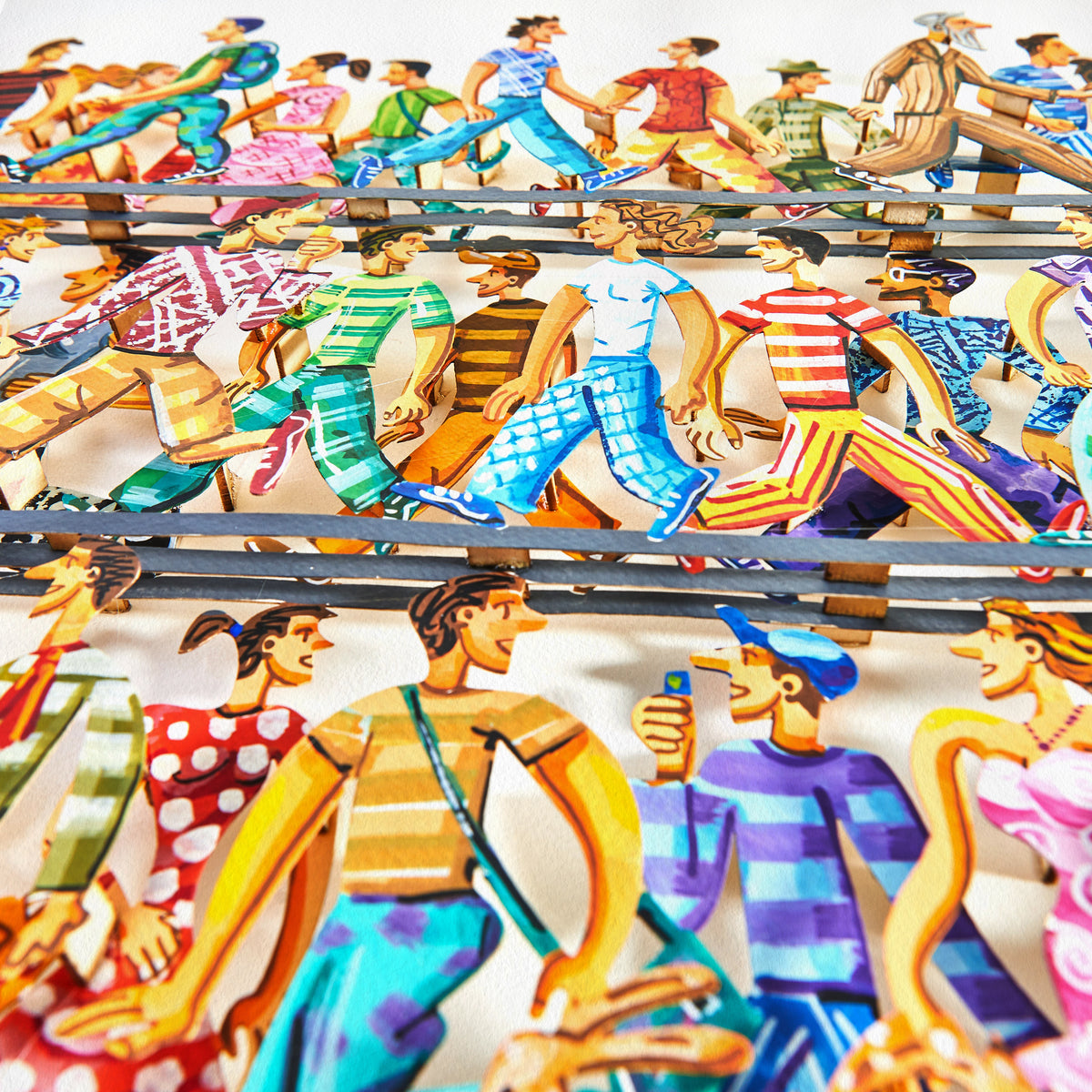 Close-up of David Gerstein's '5th Avenue' papercut artwork, showcasing all three layers with intricate details and vibrant colors from an angled perspective.