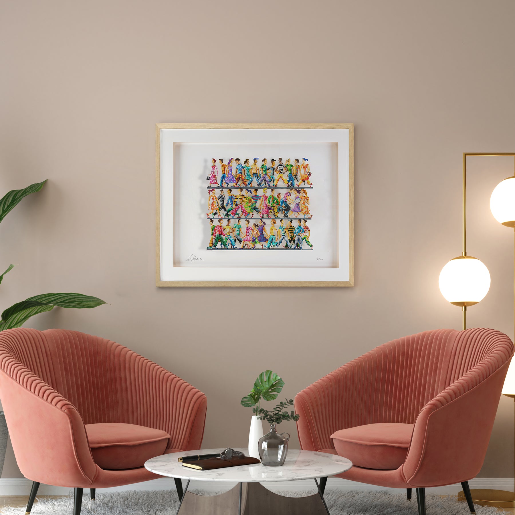 "5th Avenue" paper cut artwork in a golden frame, displayed on a wall above two pink chairs in a modern setting.