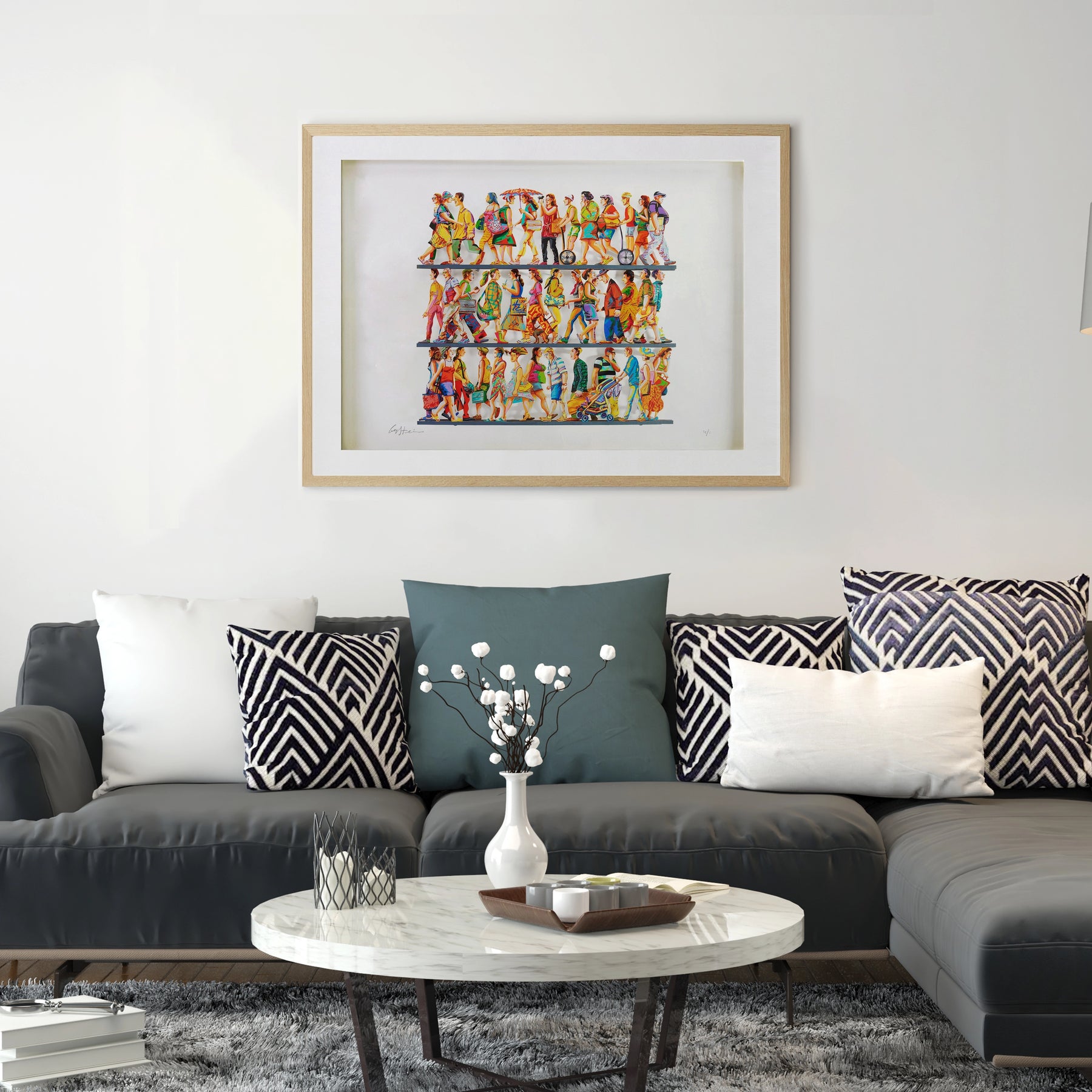 David Gerstein's '5th Avenue' papercut sculpture framed and displayed on a white wall above a sleek couch in a modern living room. The artwork's dynamic layers and vivid colors add a contemporary touch, complementing the clean, minimalist aesthetic of the space.