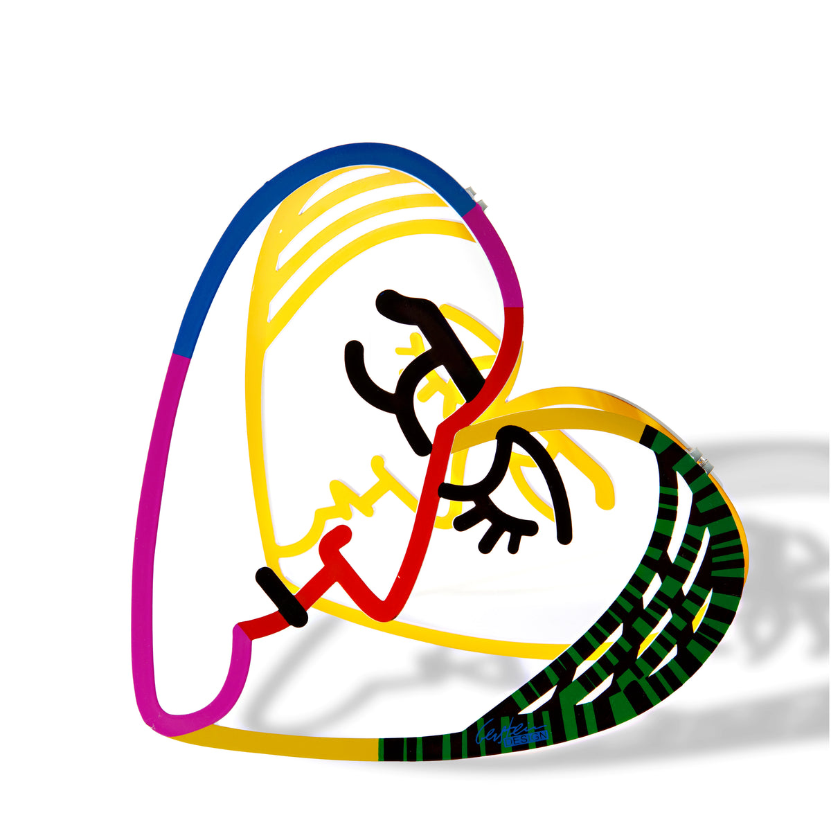 Small metal sculpture of a heart with two faces inside, displayed on a clean white backdrop. The sculpture’s intricate design stands out, showcasing its artistic details and unique form.