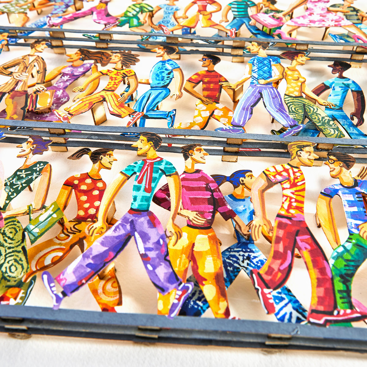 Close-up of David Gerstein's papercut artwork "5th Avenue," featuring colorful pedestrians layered in a vibrant, hand-painted cut-out paper style.