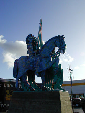 Colorful horse statue with a tower in the background